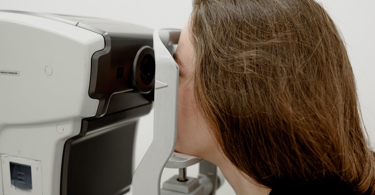 A woman receives an eye exam using advanced medical equipment at a clinic.